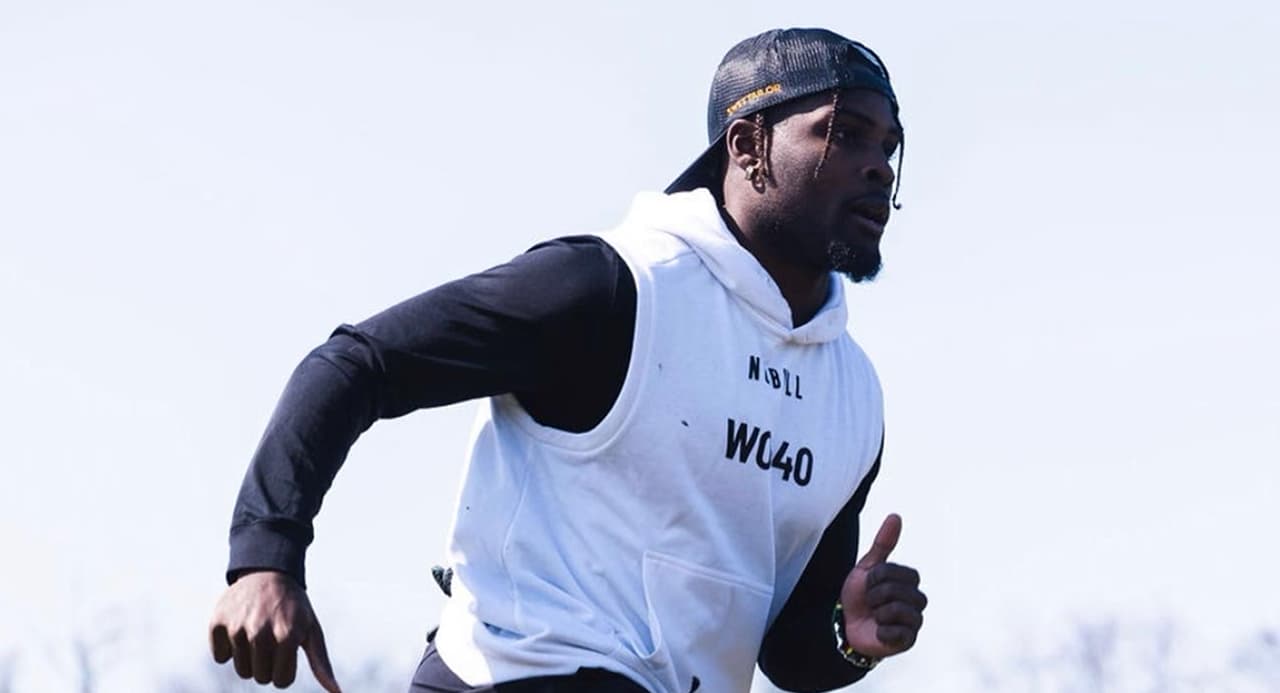 Jayden Reed throwing a football